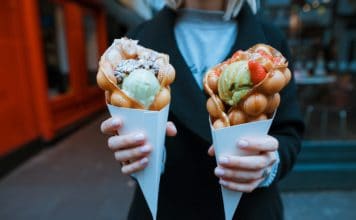 How to NOT get Food Poisoning while travelling Woman holds up two giant ice cream cones