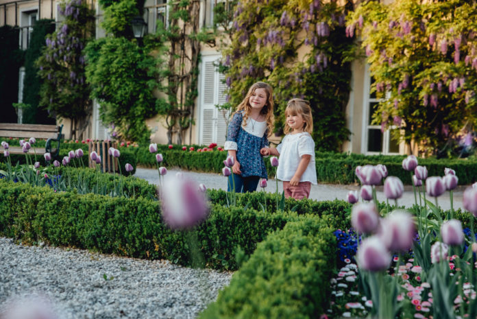 Two children enjoy the spring flowers in Salzburg, Austria