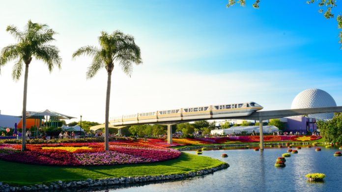 Train passes by in on of the many family friendly them parks in the city