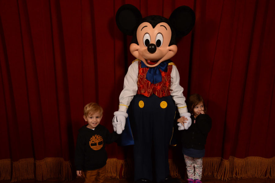 Two toddlers pose with Mickey Mouse in Walt Disney World. Taken by a Disney Photographer.