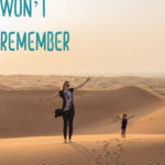 Mother and toddler walk in Dubai desert during a family holiday