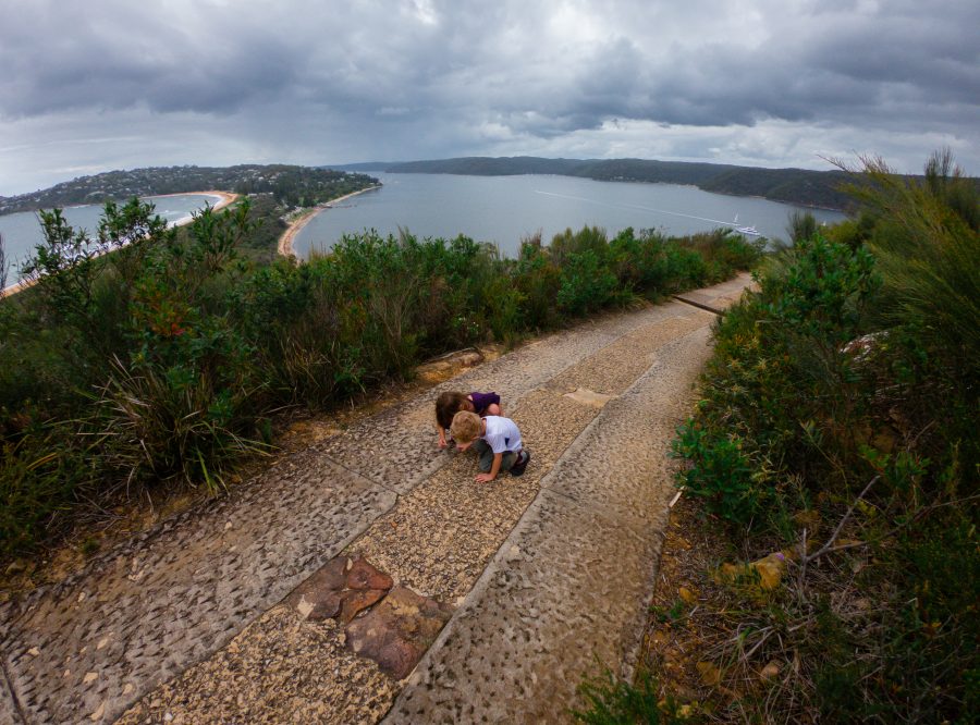Two children walk along the Barrenjoey lighthouse walk 
