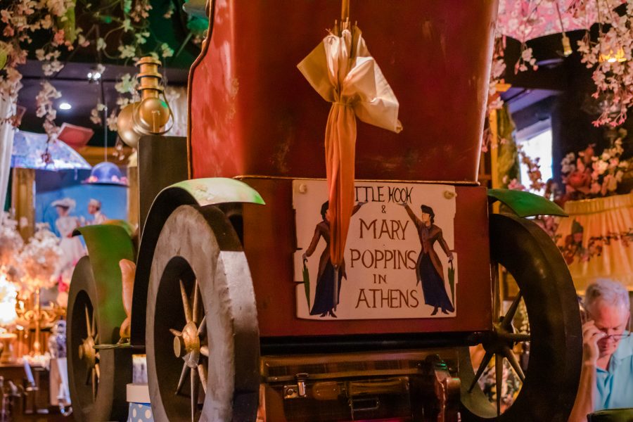 Red carriage with sign displaying "Mary Poppins comes to Athens"