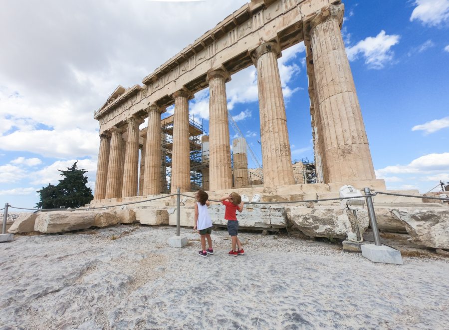 Children stare upwards at the Acropolis in Athens